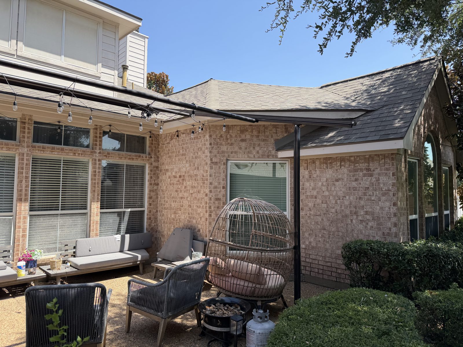 Existing brick home courtyard and patio with pergola frame before construction in Richardson, TX